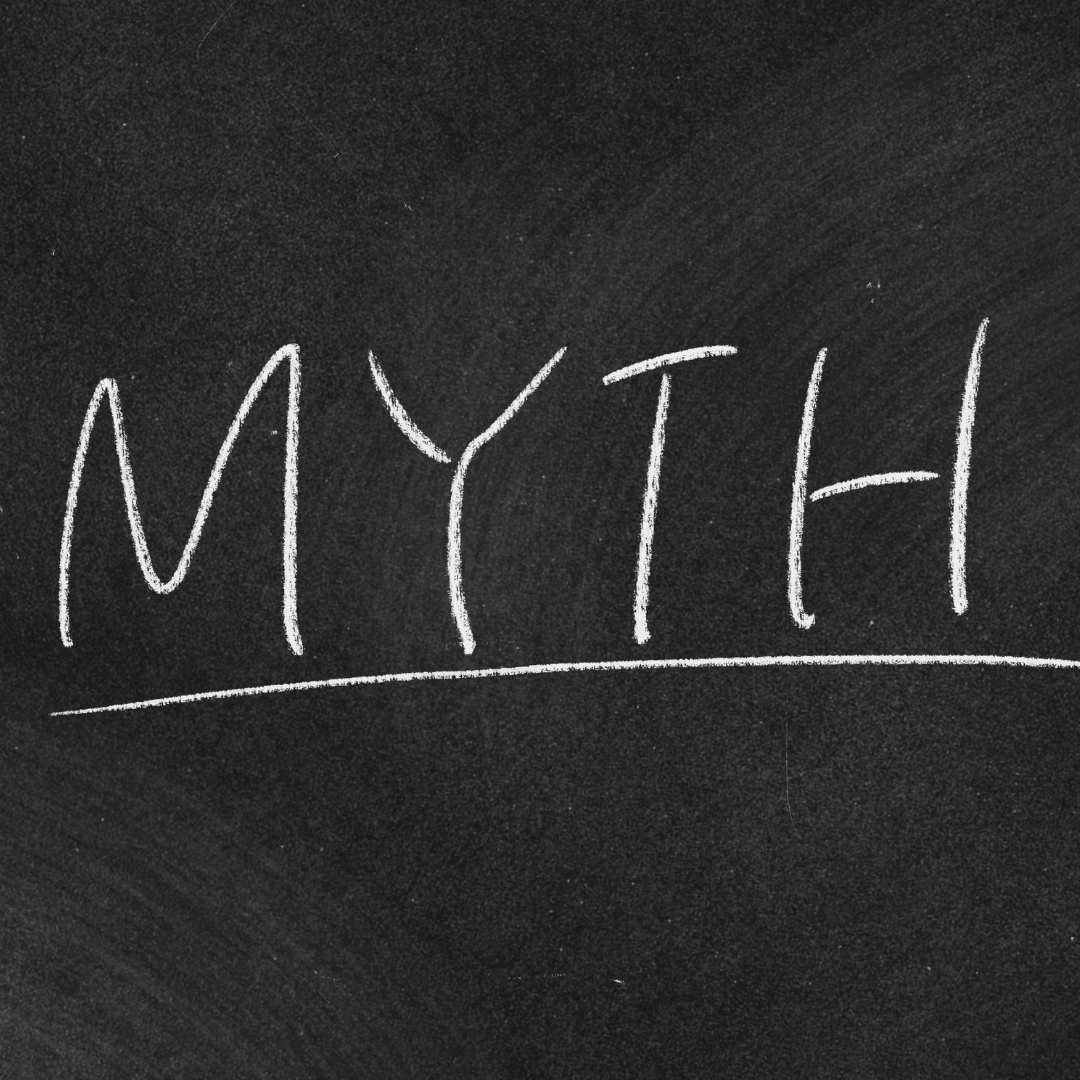 The word "Myth" is written on a black chalkboard in white chalk.