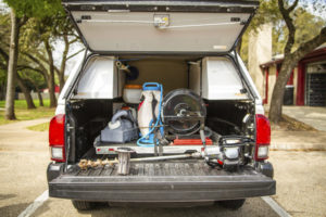 All the tools of the trade are shown in the back side of a pickup truck.