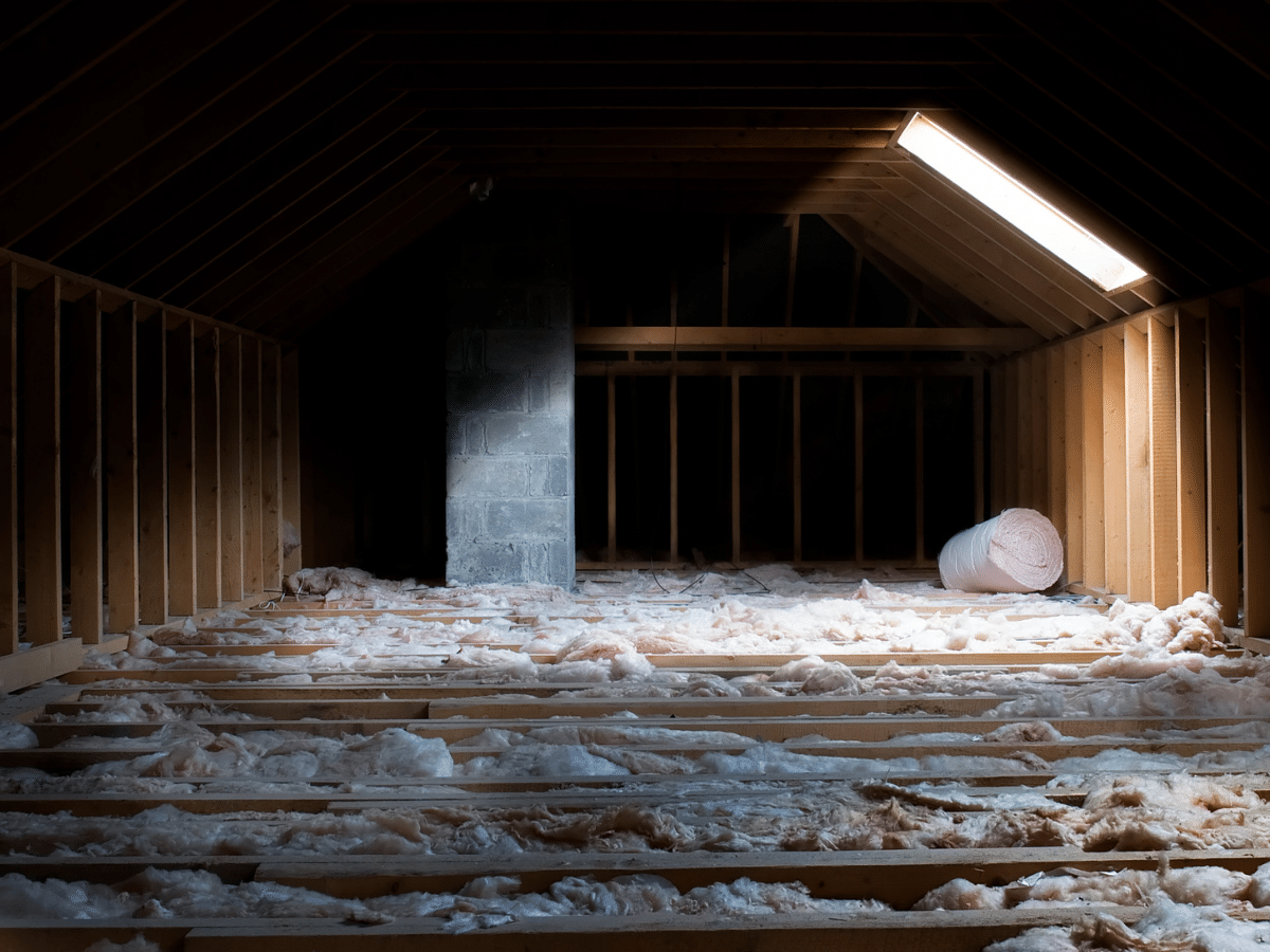 Dark attic with insulation in exposed in the floor