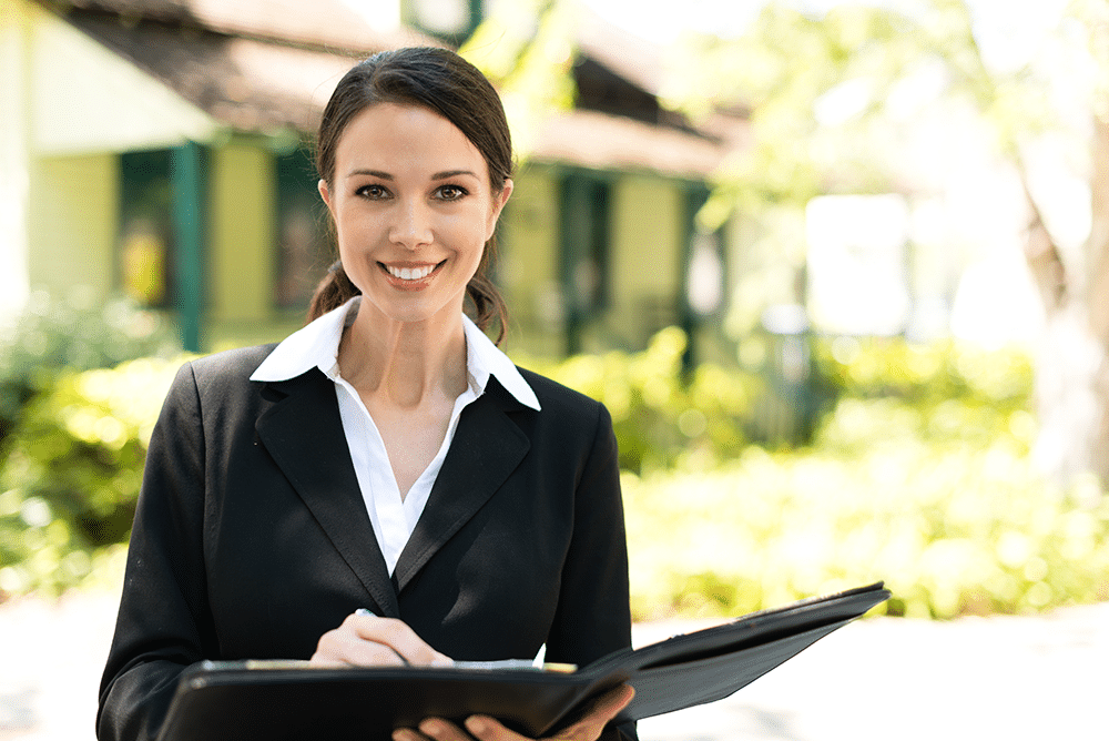 real estate inspector in front of home